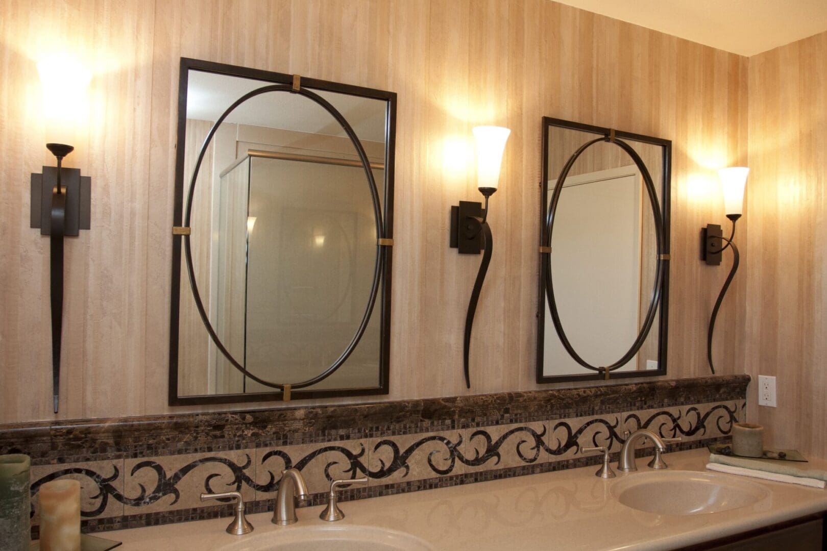 A bathroom with two mirrors and a sink