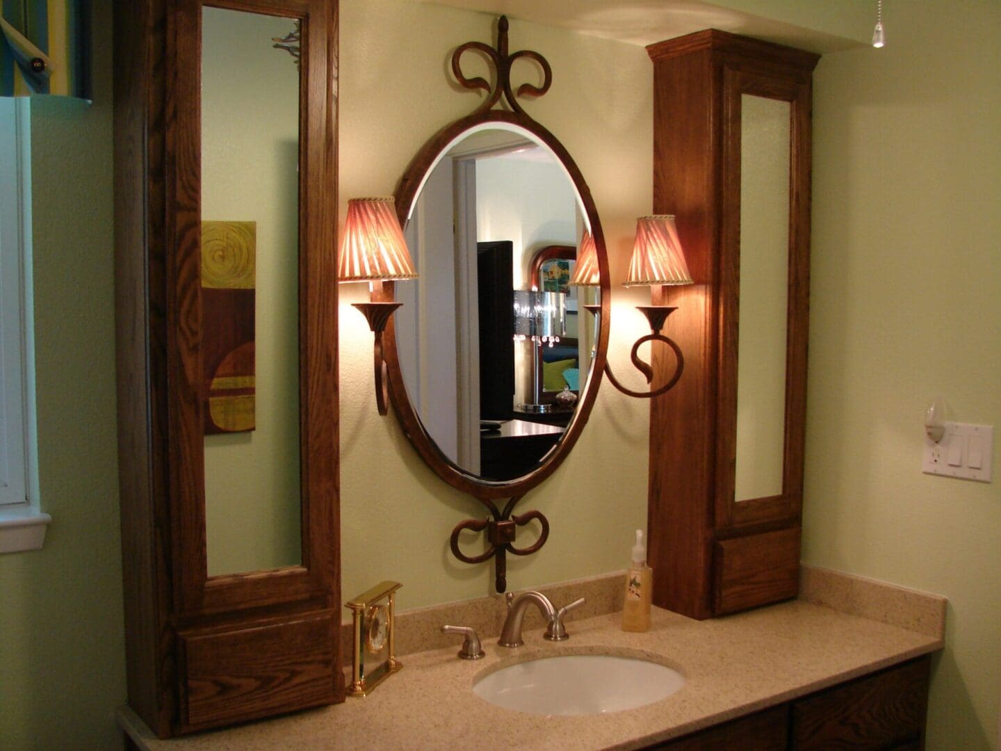 A bathroom with a sink, mirror and lights.