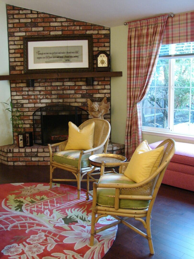 A living room with two chairs and a fireplace.